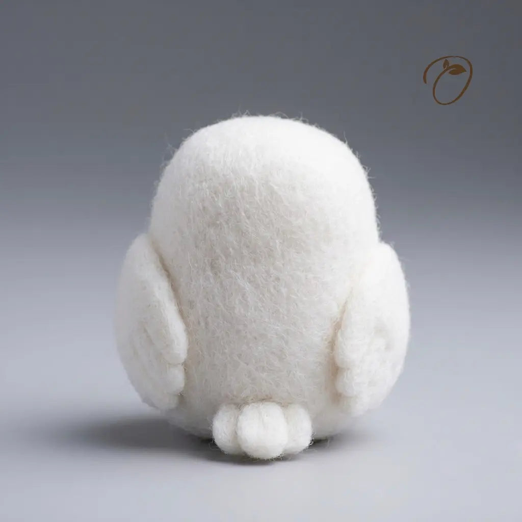A white, fluffy felt bird figurine shown from the back, photographed against a smooth gray gradient studio background.