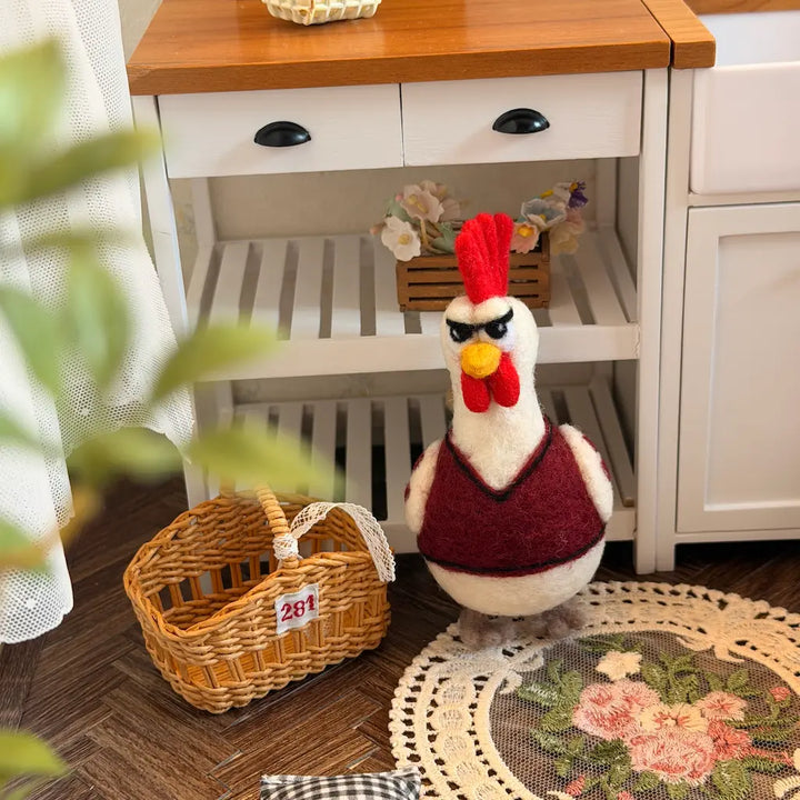 Rooster figurine in a home setting with a wooden cabinet and decorative items.
