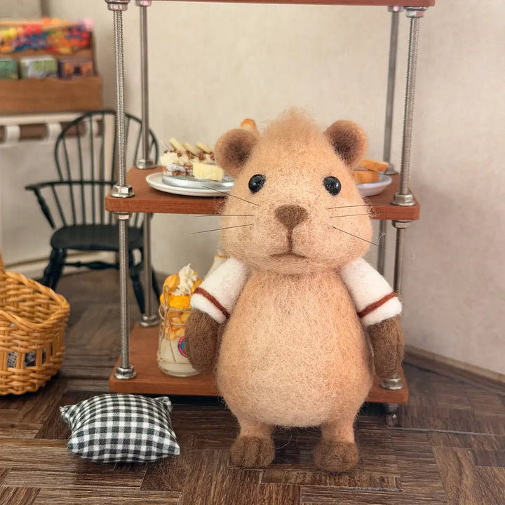 Capybara figurine standing on a wooden floor.