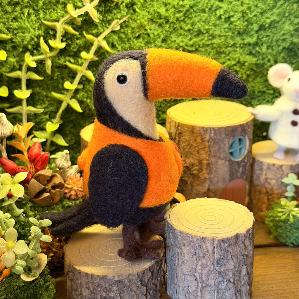 Toucan figurine on a wooden stump with a forest background