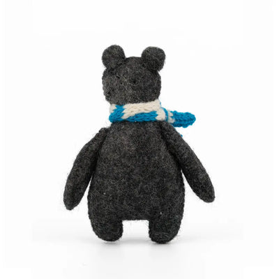 Stuffed animal toy with a blue scarf on a white background