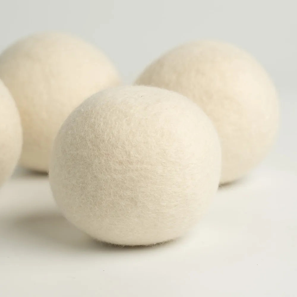 Close-up shot of a single 100% organic wool dryer ball, showing its dense, hand-felted texture.