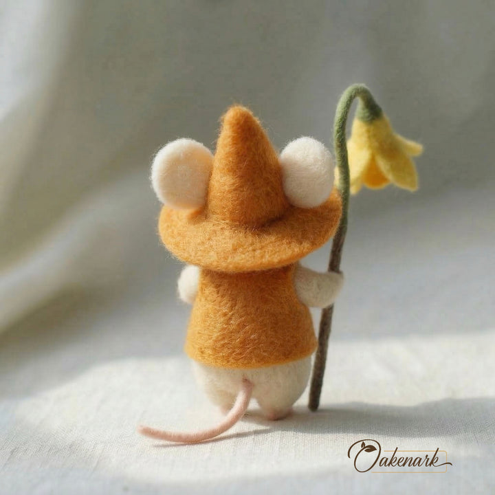 Felted mouse holding a yellow flower on a soft background with &