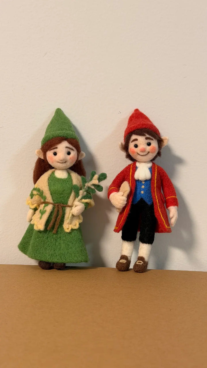 Two toy figurines, one in green and one in red, standing on a brown surface with a white background.