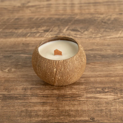 OakenArk Tropical Coconut Scented Candle in a natural, hand-poured coconut shell with a wooden wic