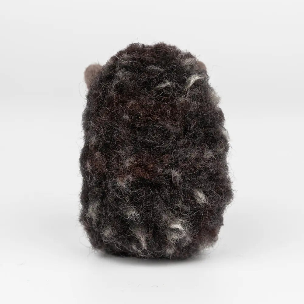 Textured black and gray object on a white background