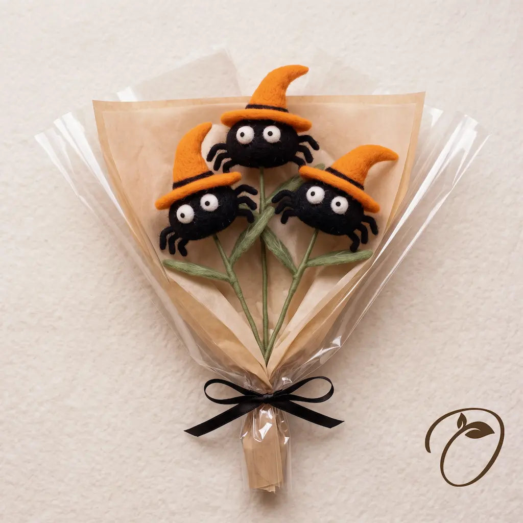 Three matching wool felt spiders in orange witch hats, wrapped together as a Halloween bouquet; stems sold individually.