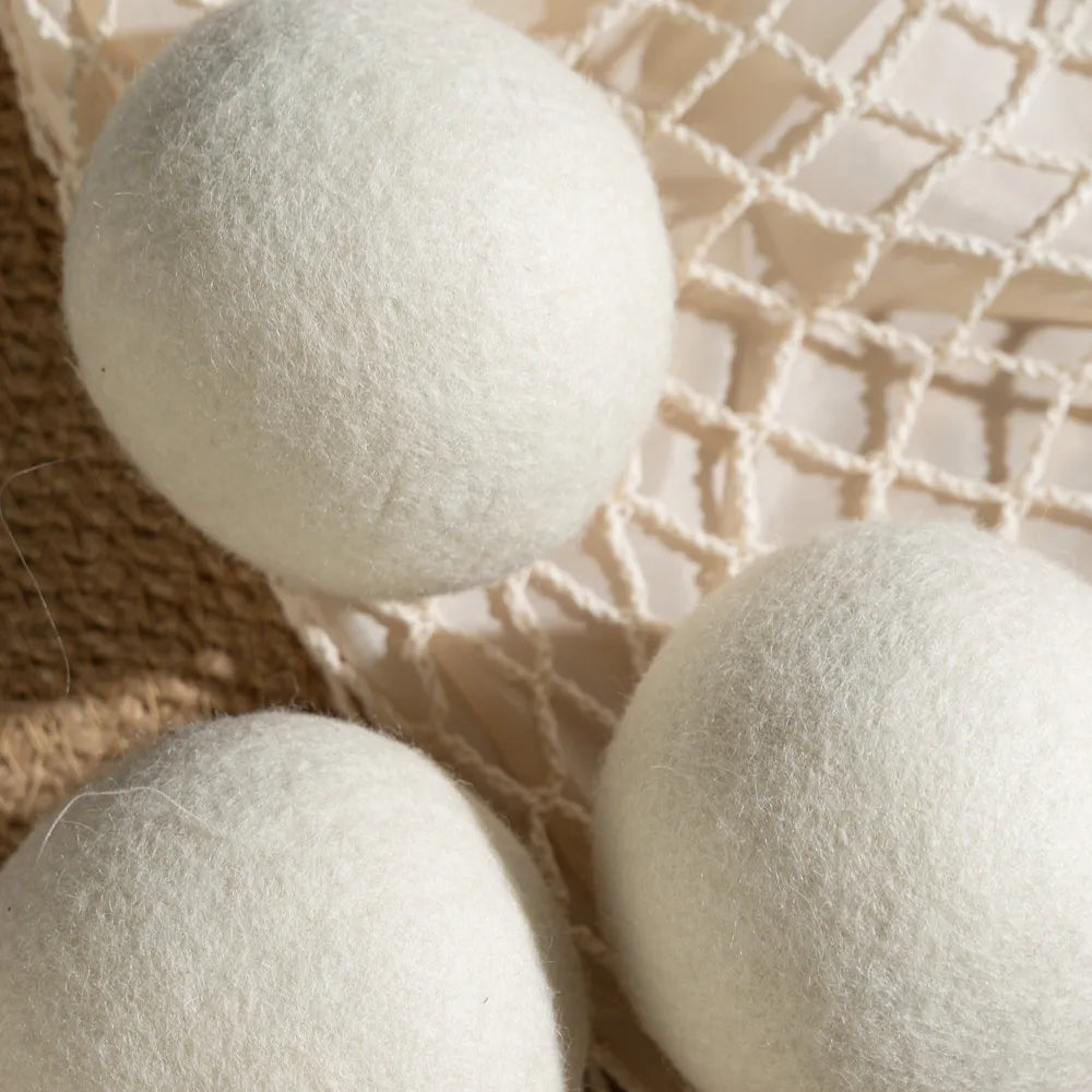 Close-up shot of a single 100% organic wool dryer ball, showing its dense, hand-felted texture.