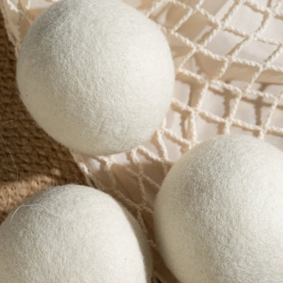 Close-up shot of a single 100% organic wool dryer ball, showing its dense, hand-felted texture.