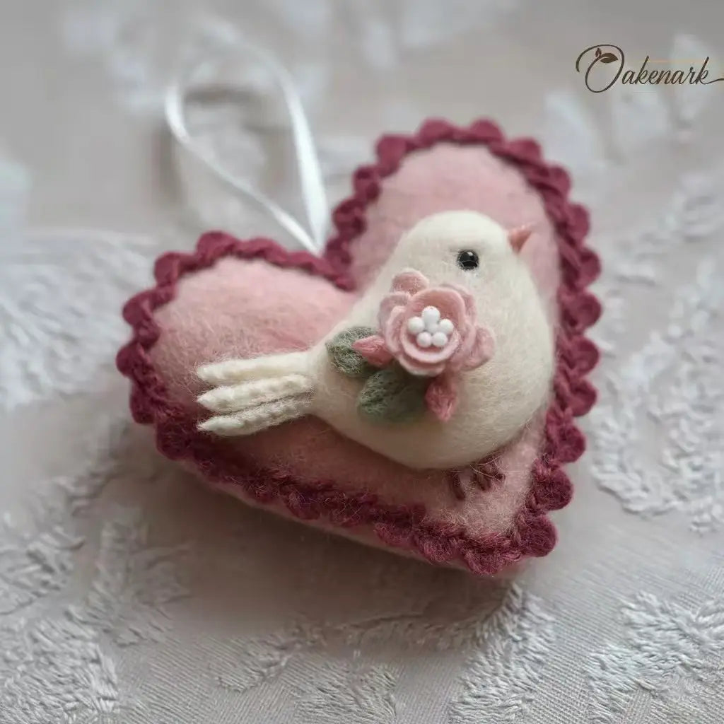 Pink heart-shaped ornament with a bird and flower detail on a textured white background