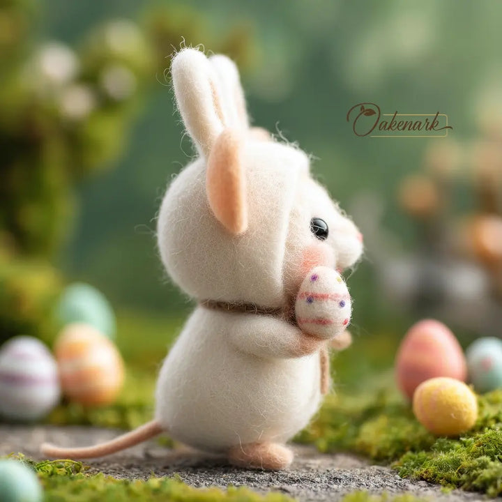 Felted mouse figurine with Easter eggs in a natural setting