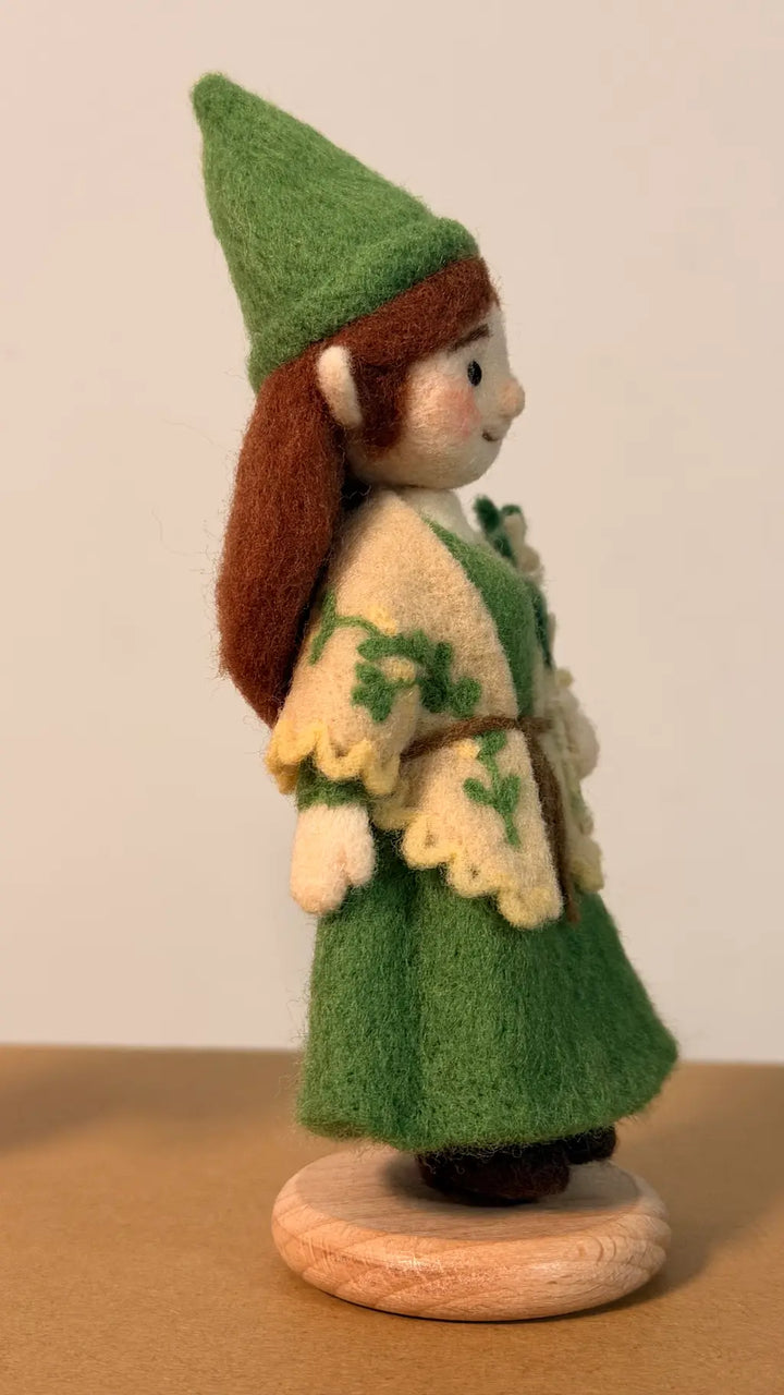 Felted elf figurine wearing a green outfit with a white background