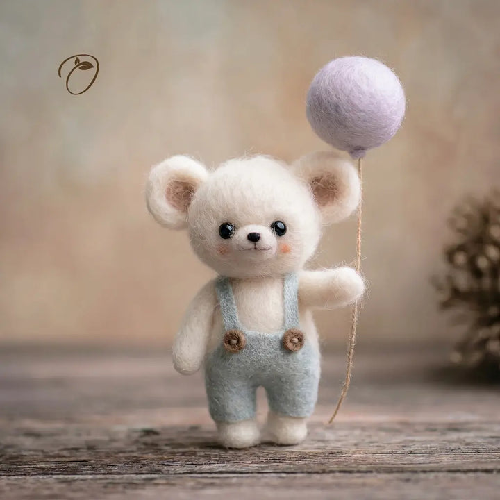 Small white teddy bear with a purple balloon on a wooden surface