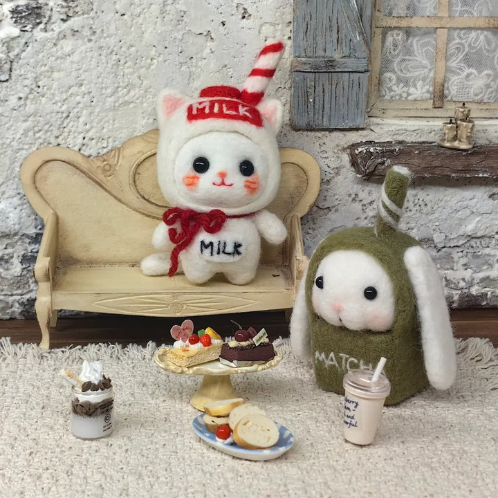 Milk Carton Cat and Matcha Bunny felt figurines with miniature cakes, bread and drinks in a cozy cafe display
