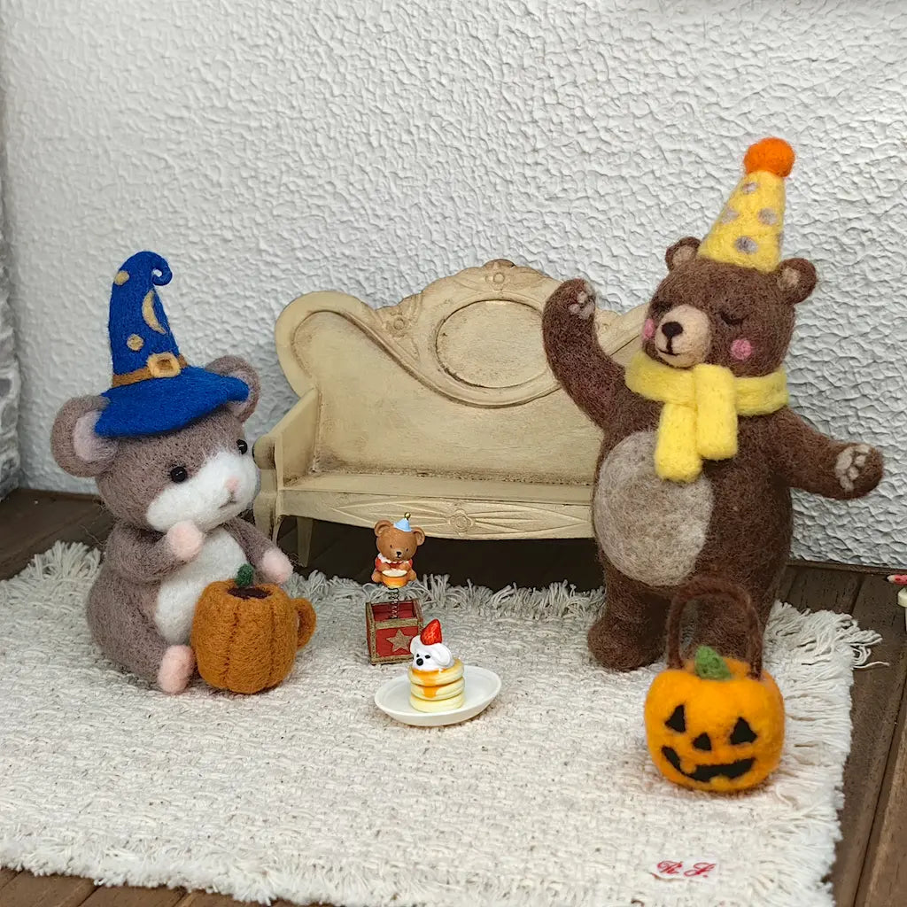 Wizard Mouse and Party Bear felt figurines in a miniature celebration scene with pumpkin basket and tiny cake