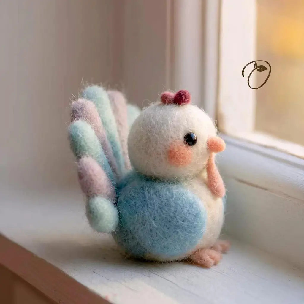 A small needle-felted bird figurine with pastel blue, cream, pink, and mint feathers, sitting on a windowsill in soft natural light.