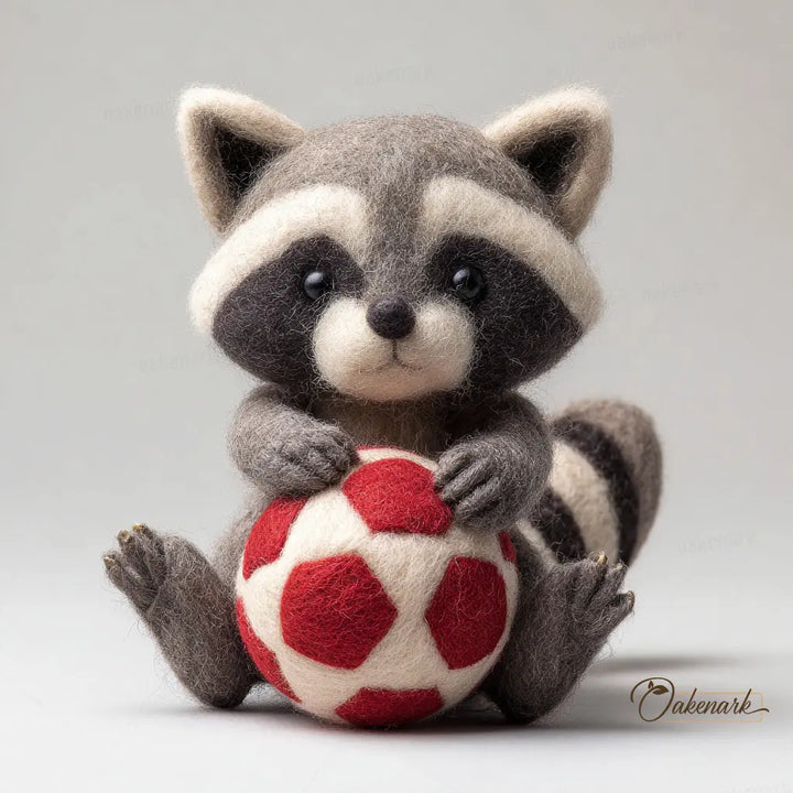 Stuffed raccoon toy holding a red and white ball on a gray background