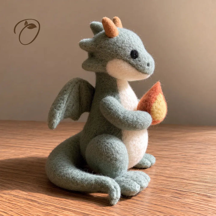 Side view of a sage green felt dragon holding an orange and yellow flame, with a cream belly, small wings and curled tail.