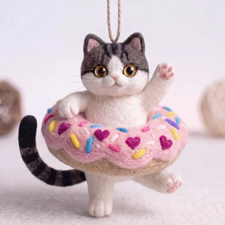 Donut Drifter Cat wool felt ornament in pink sprinkle donut with raised paw