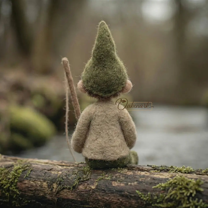 Small gnome figurine with a moss-covered hat sitting on a log in a forest setting.