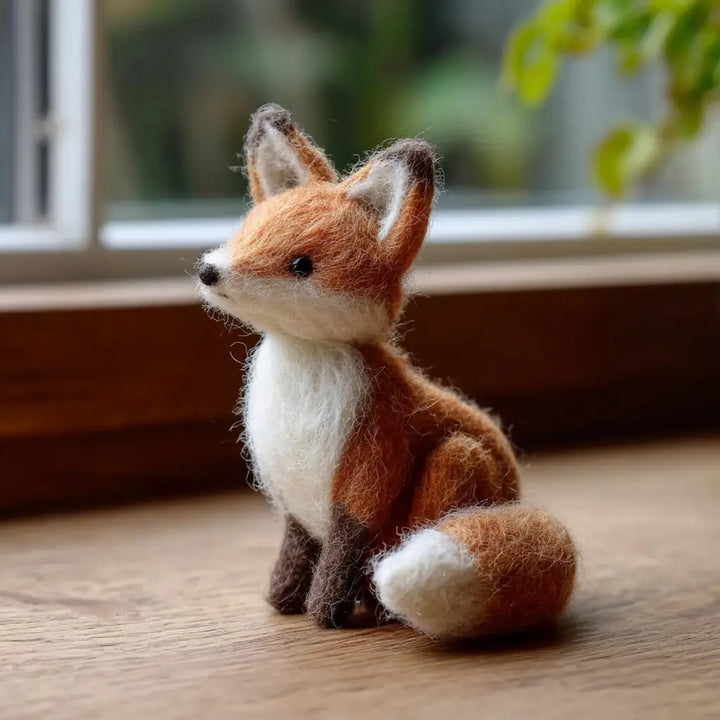Handmade red fox felt figurine in a natural seated pose