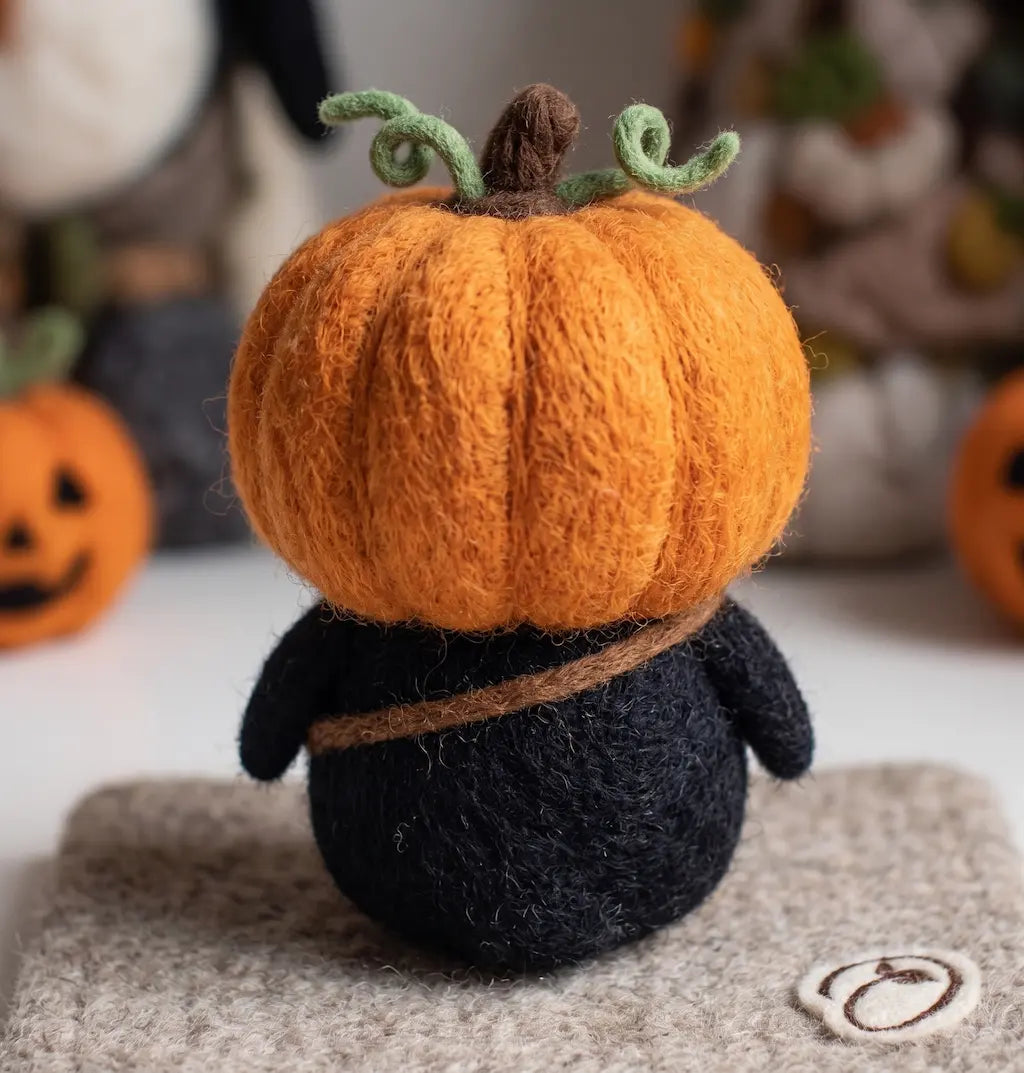 Back view of Pumpkin Rascal Penguin showing orange pumpkin hood, stem and green vines