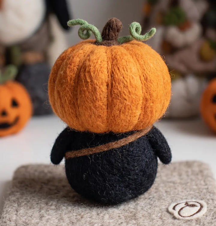 Back view of Pumpkin Rascal Penguin showing orange pumpkin hood, stem and green vines