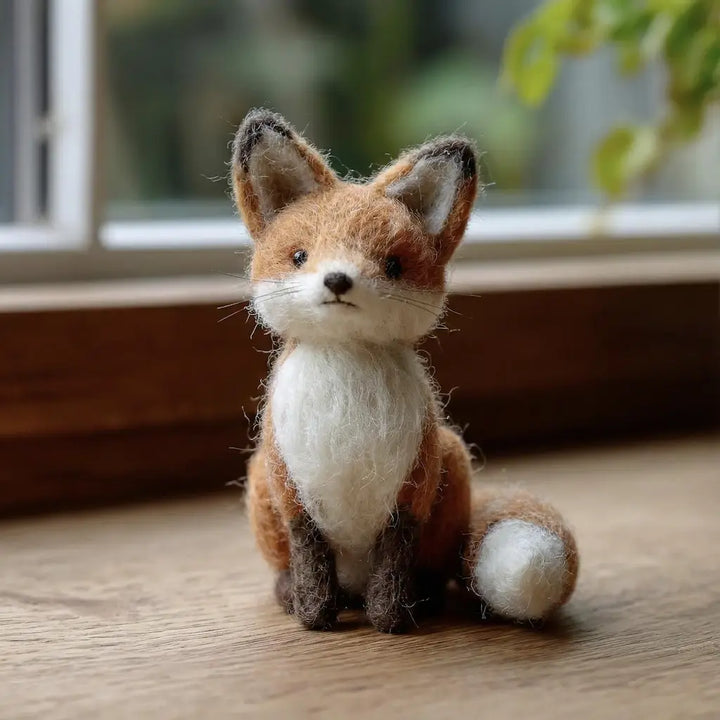 Woodland red fox wool felt figurine sitting with a white chest and bushy tail