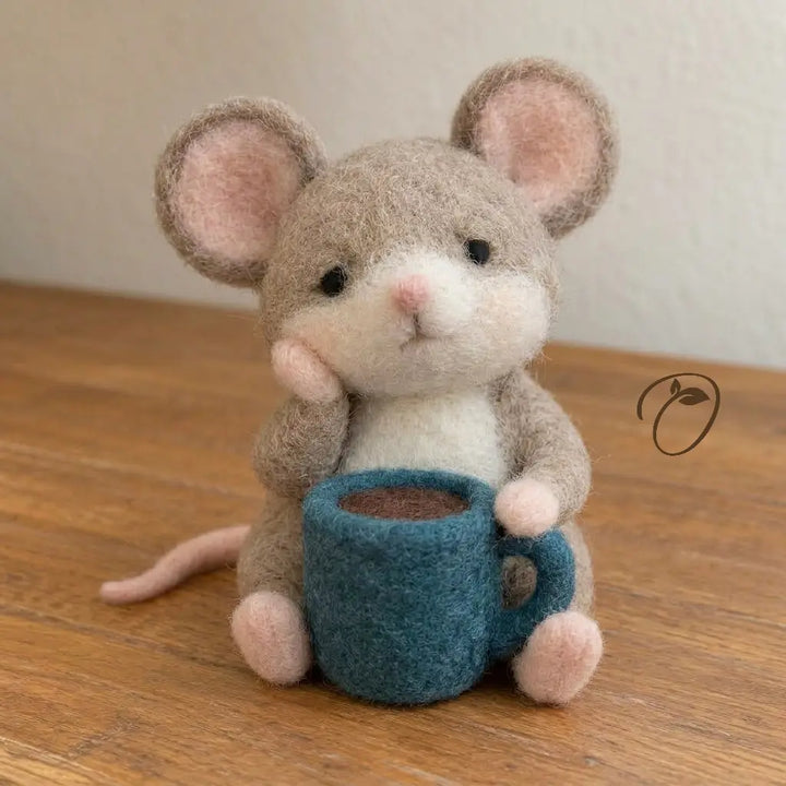 Back view of handcrafted wool felt mouse with long pink tail