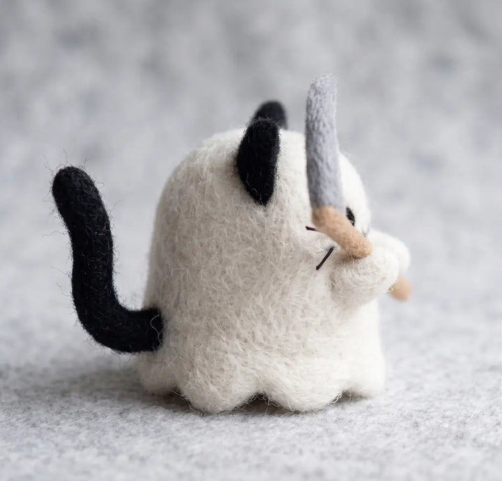 Side view of Ghost Cat felt figurine with long black wool tail