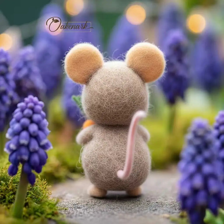 Small mouse figurine among purple flowers with a blurred background