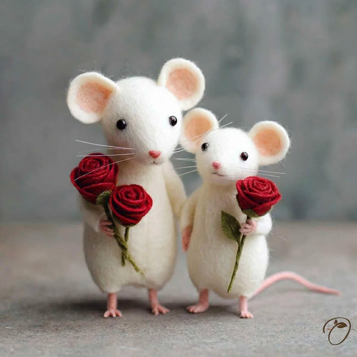 Two white mouse figurines holding red roses against a gray background