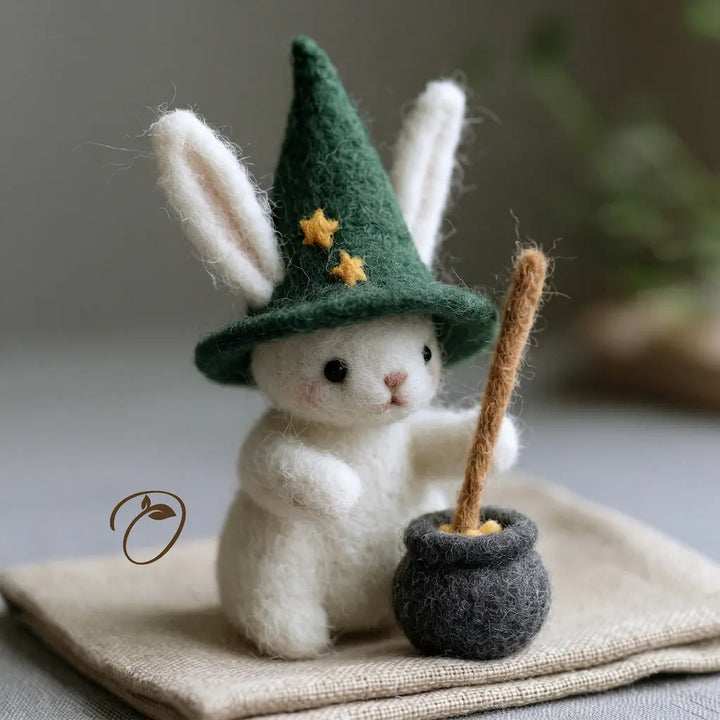White bunny wool felt figurine with green star hat and cauldron