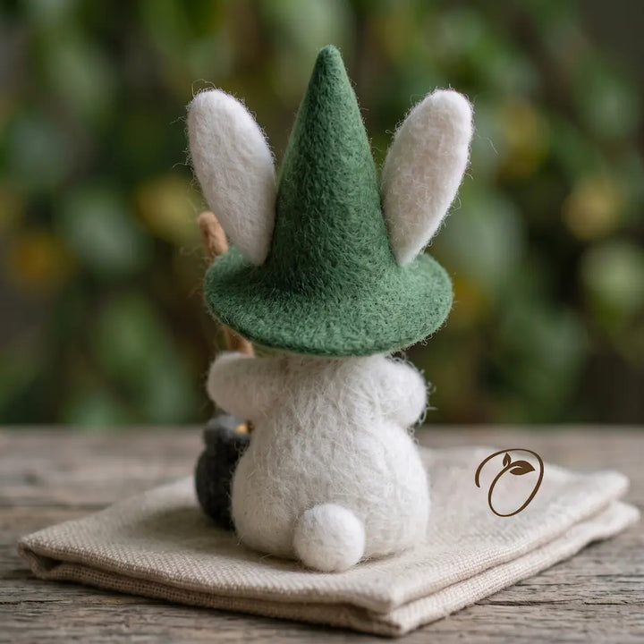 Back view of white bunny wearing forest-green pointed felt hat