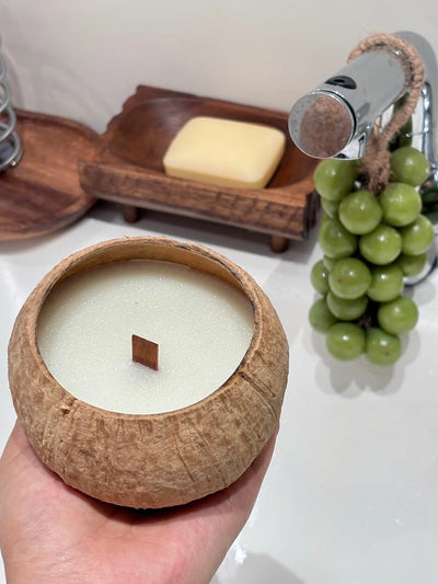 OakenArk Tropical Coconut Scented Candle in a natural, hand-poured coconut shell with a wooden wic