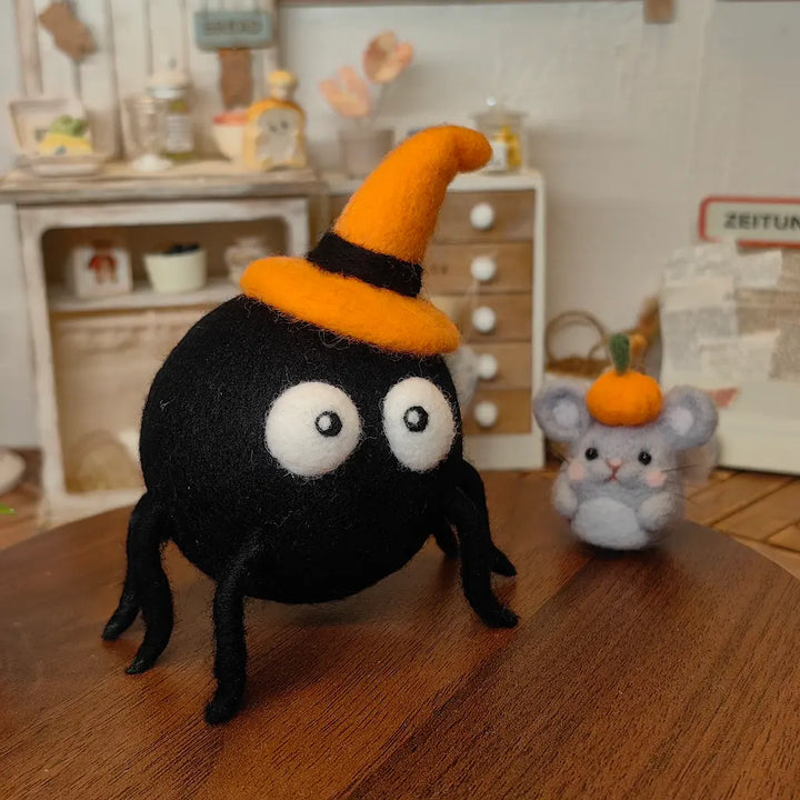 Midnight Spider felt figurine in an orange witch hat beside a small pumpkin mouse Halloween character