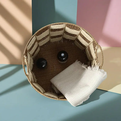 The round woven basket holding a white towel and decorative items, showcasing its storage capacity
