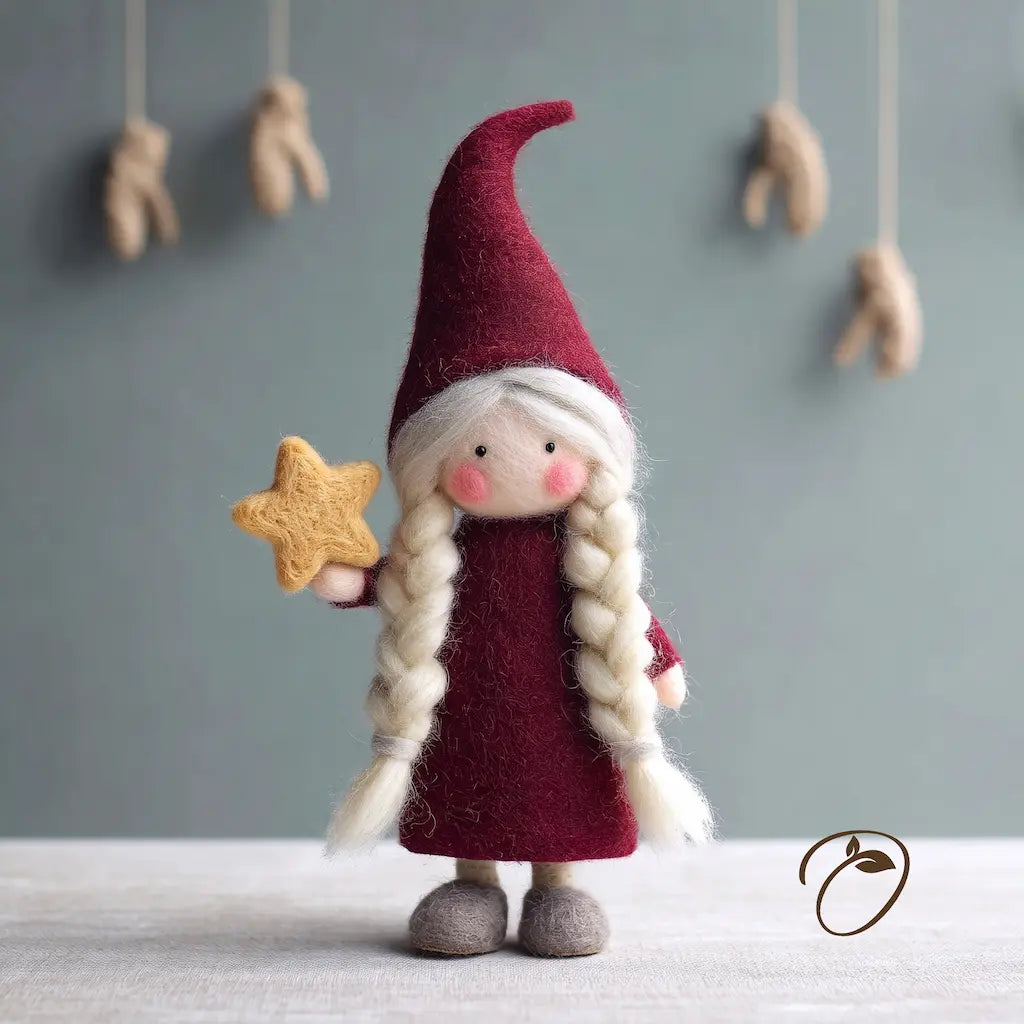Front view of Nordic Mrs. Claus felt figurine with silver-white braids, a burgundy hat and dress, and a golden star.
