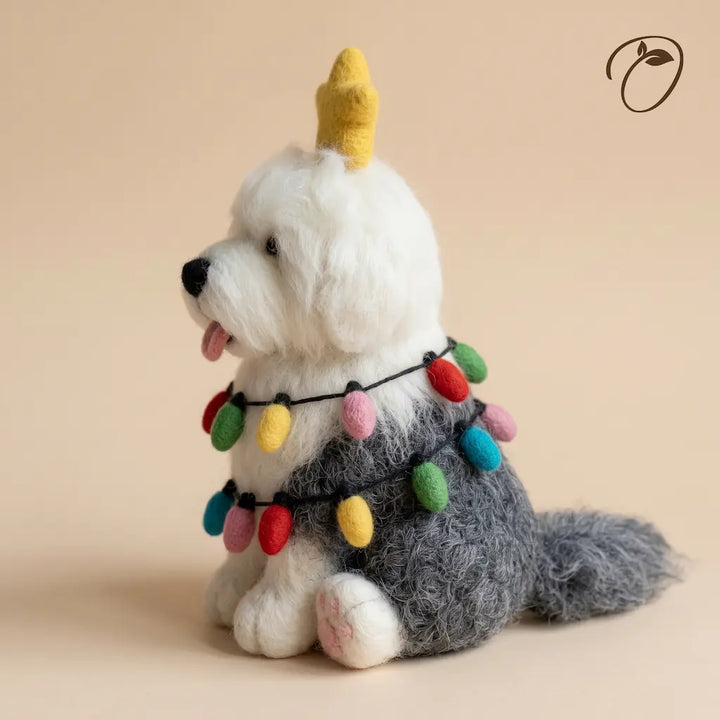 Side view of a gray and white Old English Sheepdog felt figurine showing its shaggy coat, bulb garland and long tail.