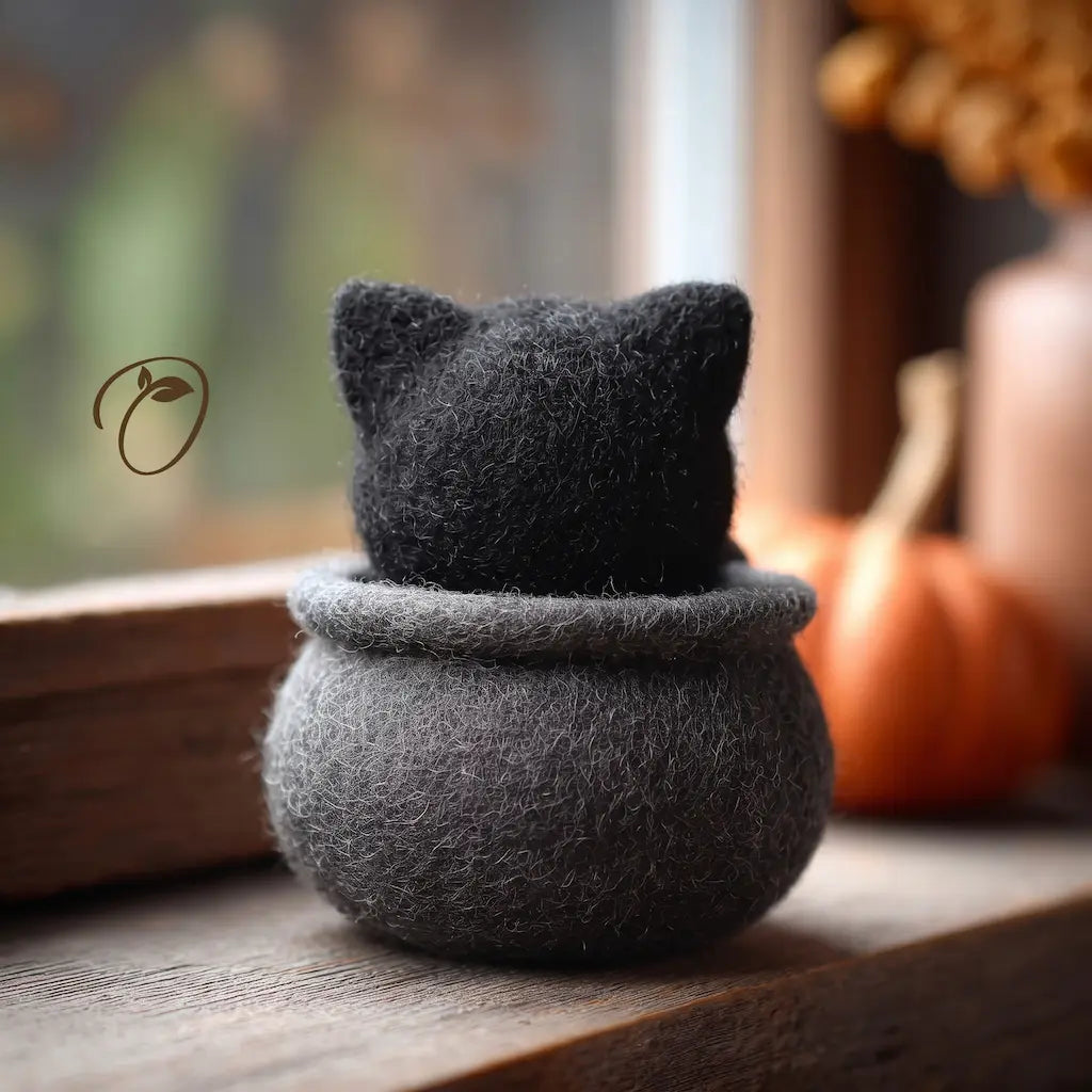 Back view of Grumpy Cauldron Cat felt figurine showing black cat ears and rounded charcoal-gray cauldron