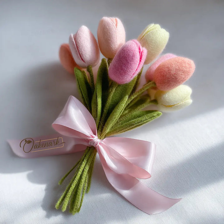 Bouquet of pink and yellow tulips with a pink ribbon on a white background