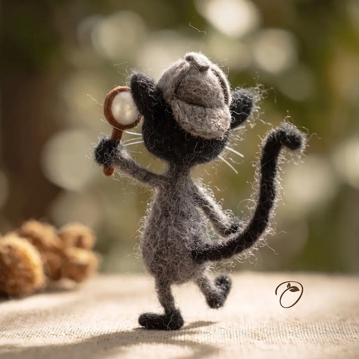 Side view of gray detective cat felt figurine wearing an investigator cap