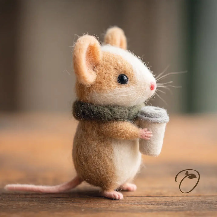 Side view of the coffee mouse felt figurine showing its scarf, takeaway cup and curved pink tail