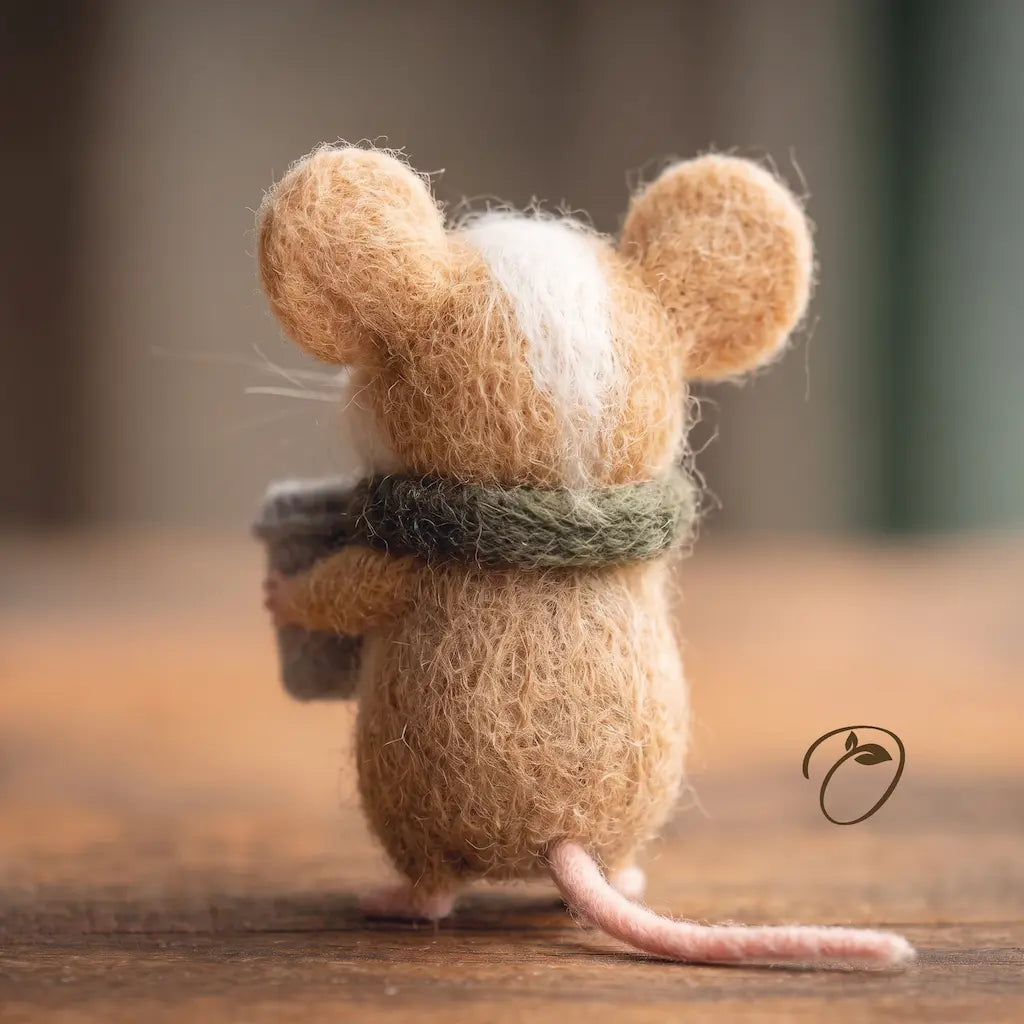 Back view of the felt coffee mouse showing its cream head stripe, green scarf and pink tail