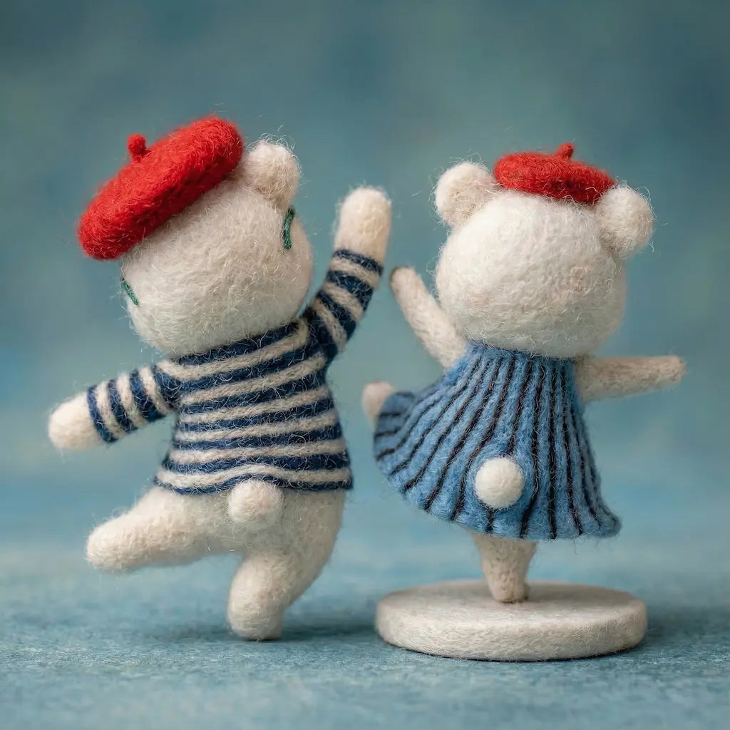 Two small teddy bears in striped outfits and red hats on a blue background