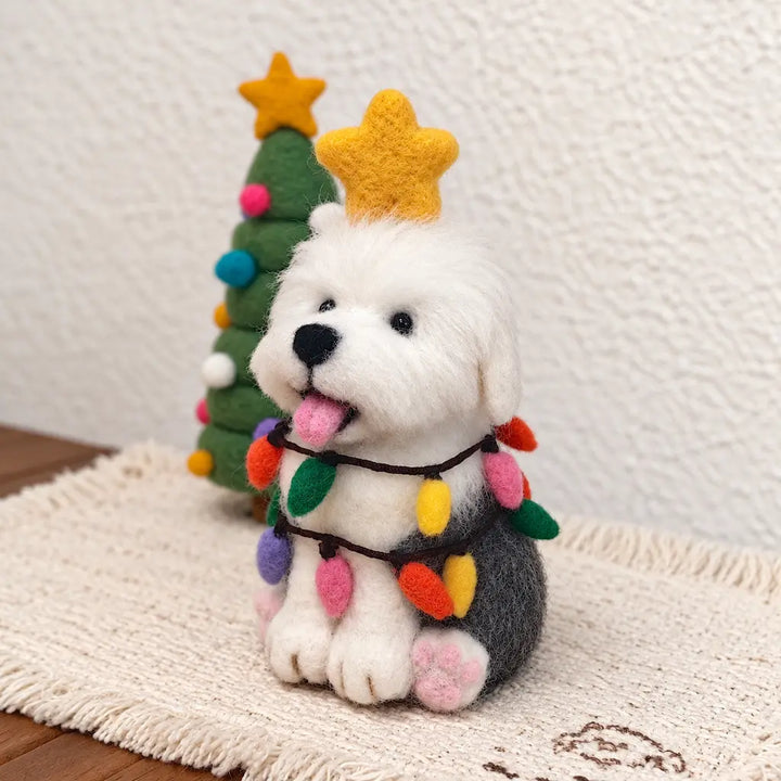 Three-quarter view of an Old English Sheepdog felt figurine with a golden star, colorful bulb garlands and pink paw pads.
