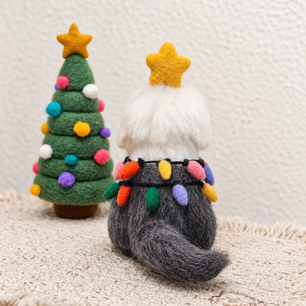 Back view of an Old English Sheepdog felt figurine showing its shaggy gray coat, curved tail and two strands of colorful felt bulbs.
