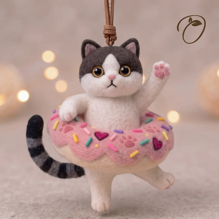 Donut Drifter Cat wool felt ornament in pink sprinkle donut with raised paw