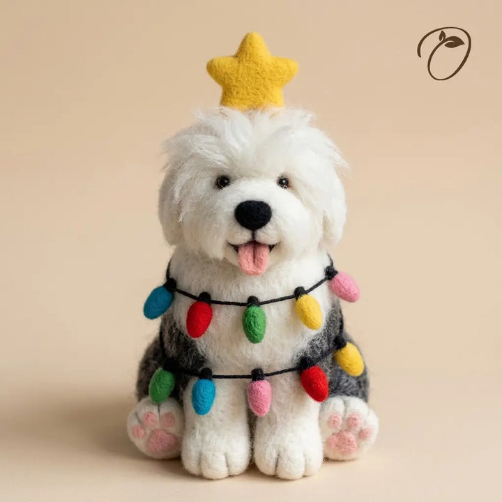 Front view of an Old English Sheepdog felt figurine with a golden star, colorful bulb garland and pink paw pads.