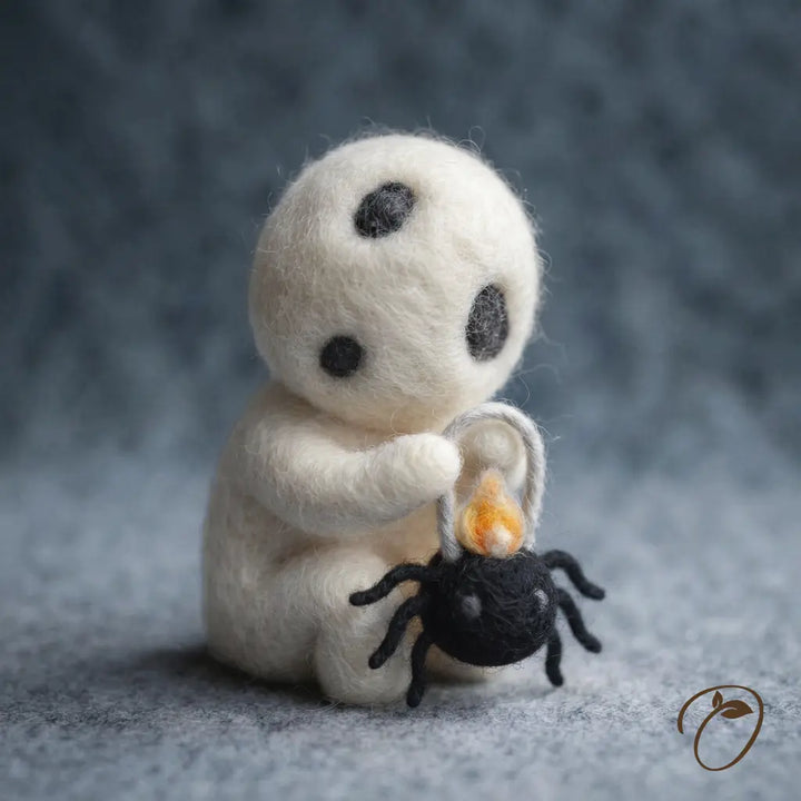 Lantern Sprite wool felt figurine with a tilted ivory head holding a black spider-shaped lantern with a felt flame
